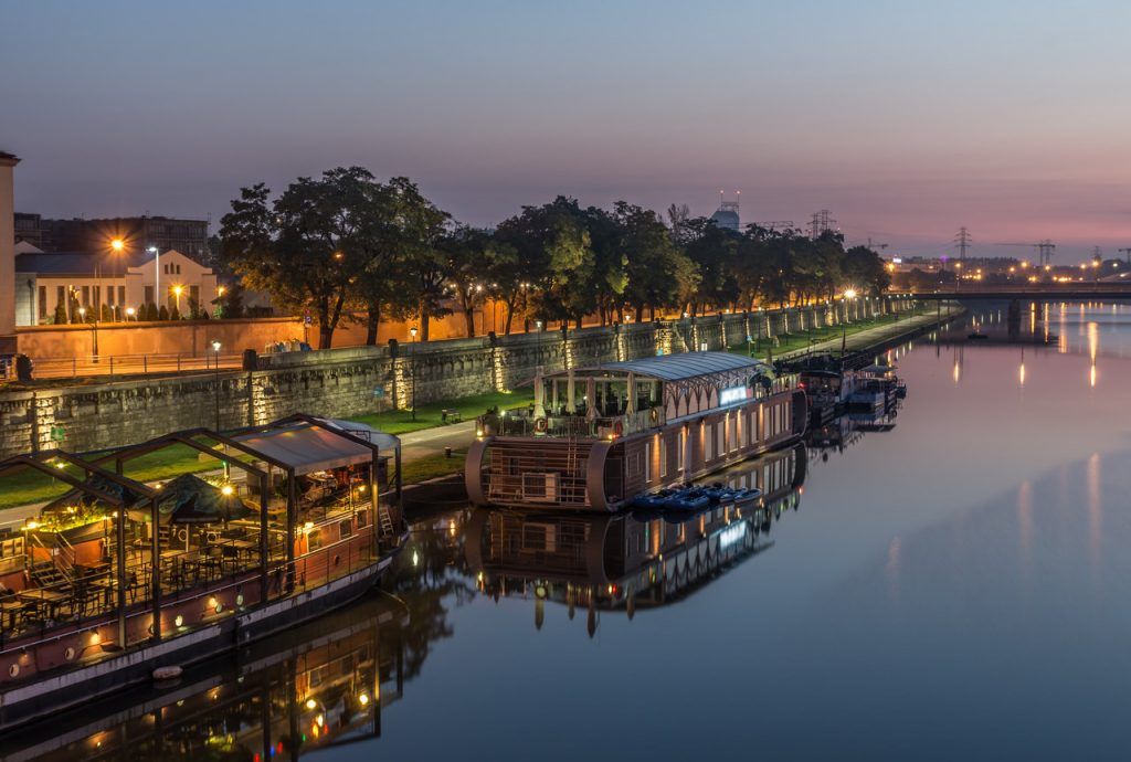 Vistula boulevards in the night in Krakow, Kazimierz district with moored ships