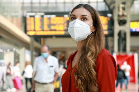 Traveler woman wearing face mask at the airport during Covid19.