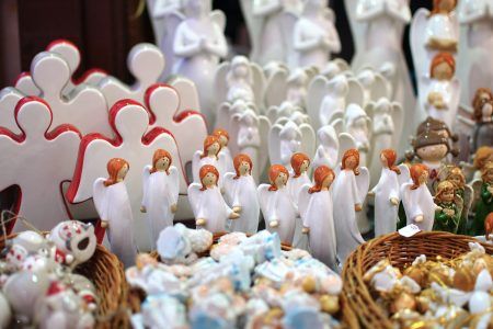Decorative porcelain figures at Cracow Christmas market. Traditional market with handmade souvenirs, Krakow, Poland