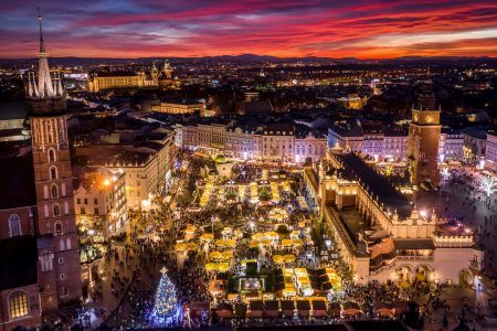 Fantastic view of the Christmas, New Year’s Fair in KRAKOW. Main Market Square and Sukiennice (The Cloth Hall) in the evening.