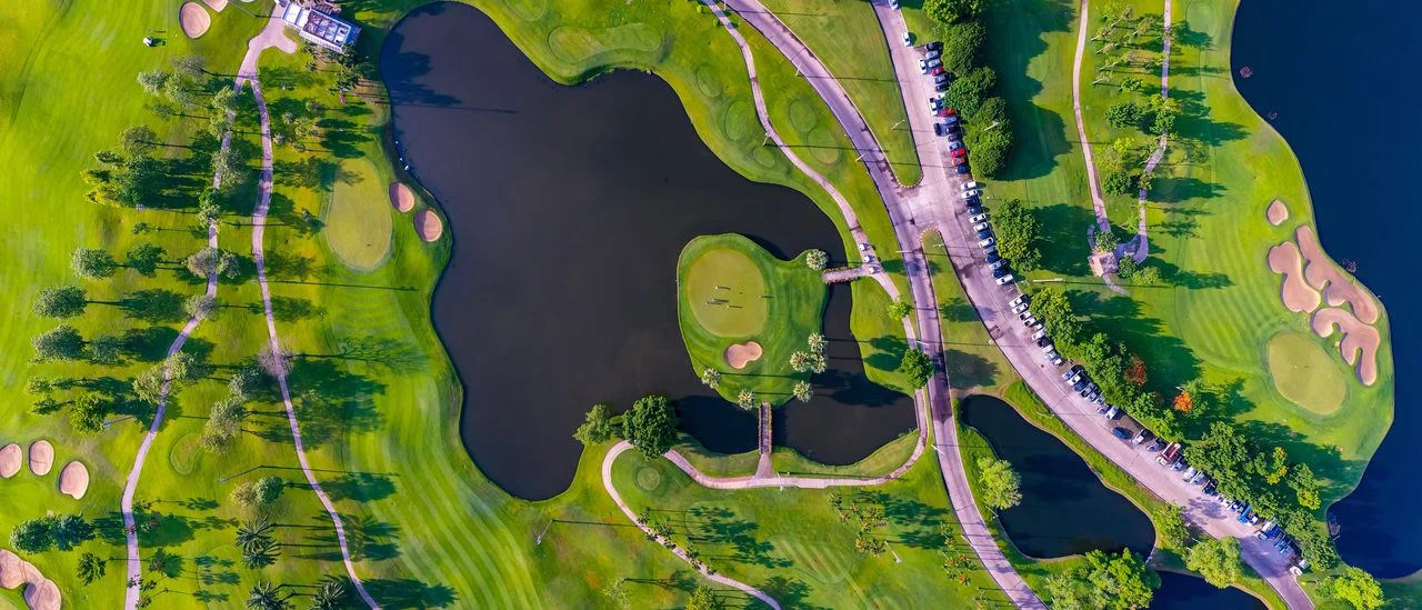 Aerial top view of golf field landscape with sunrise view in the morning shot. Bangkok Thailand
