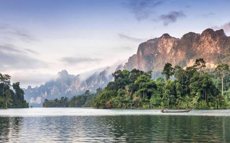 Amazing view of Khao Sok National Park in the evening time with lonly boat on the lake. South of Thailand