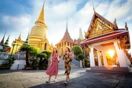 Asian girl walk at Wat Phra Kaew and Grand Palace travel in Bangkok city, Thailand