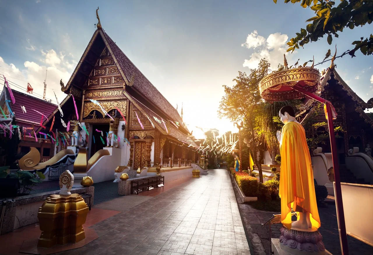 Buddha statue in yellow robe at Wat Rong Khun The Phra Sing in Chiang Rai, Thailand