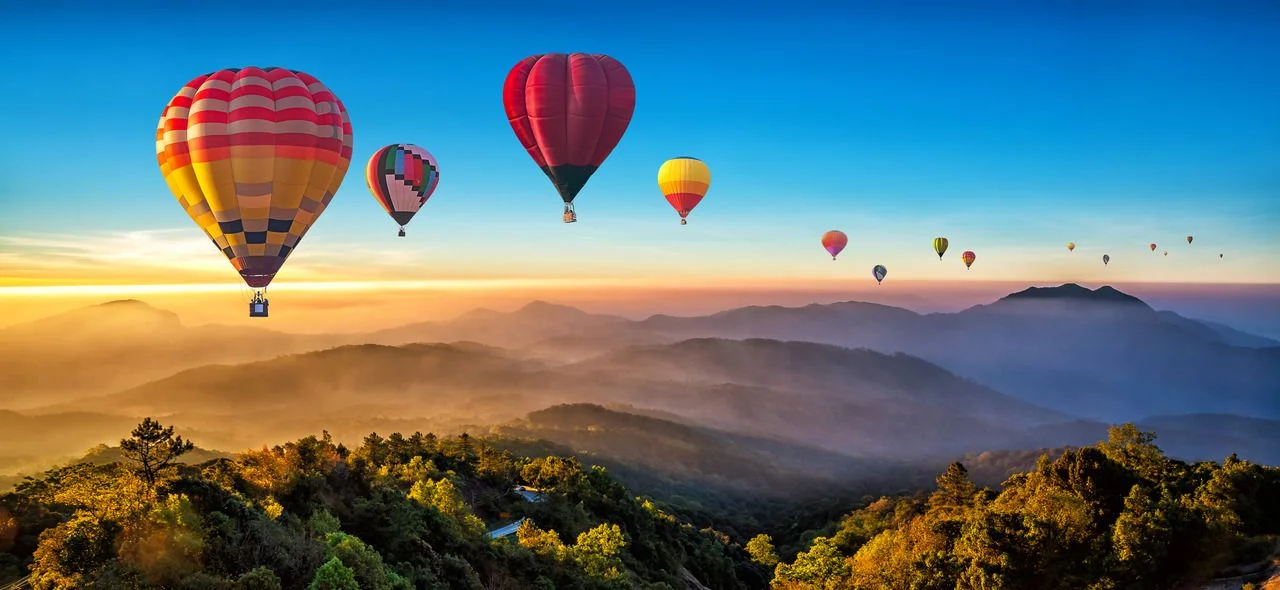Colorful hot air balloons flying over the mountains at Dot Inthanon in Chiang Mai, Thailand