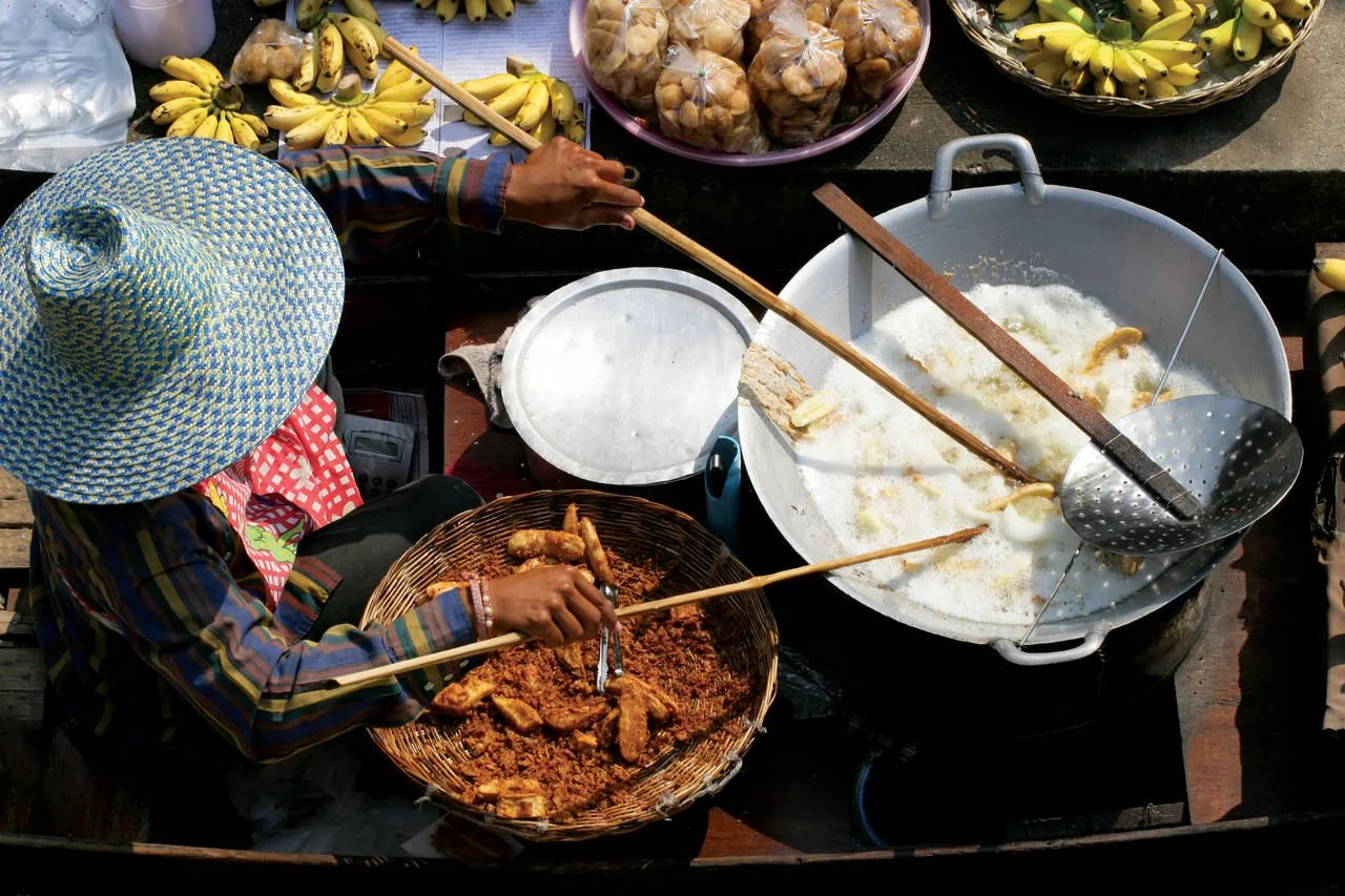 Frying up bananas in the Damnoen Saduak Floating Market in Thailand.