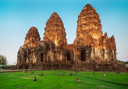 Many monkeys in archaeological site Phra Prang Sam Yod The castle of Lopburi city, Thailand