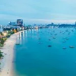 Ships in turquoise water. North Pattaya Beach at night.