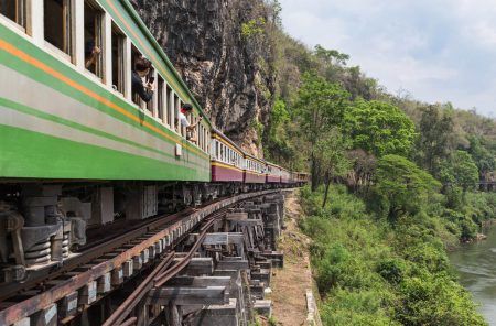 passenger thai train moving on death of railway world war II between tham krasae railway station river kwai kanchanaburi Thailand