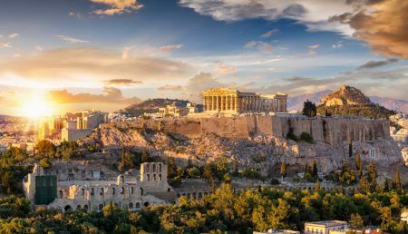 Acropolis of Athens, Greece, with the Parthenon Temple atop the hill during the summer sunset