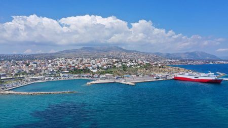 Aerial drone bird’s eye panoramic view of famous port and city of Rafina with passenger ferries travel to Aegean islands, Attica, Greece