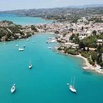 Aerial drone bird’s eye view photo of famous and picturesque yacht dock seaside fjord village of Porto Heli with turquoise and emerald clear waters, Argolida, Peloponnese, Greec