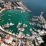 Aerial drone bird’s eye view photo of iconic round shaped picturesque port of Mikrolimano with sail boats and yachts docked and beautiful colours, Piraeus port, Attica, Greece