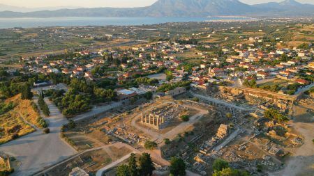 Aerial drone photo of iconic archaeological site of Ancient Corinth built in the slopes of Acrocorinth, Peloponnese, Greece