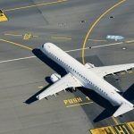 Aerial view of airport. Airplane taxiing to runway before take off.