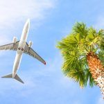 Airplane Is Flying In Cloudy Sky Over Island And Sea In Summer At Seychelles