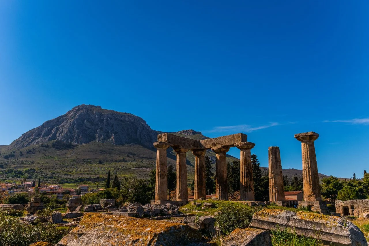 Archaeological Site Of Corinth And Temple of Apollo with Acrocorinth fortress for background. The Temple of Apollo in Ancient Corinth and the Acrocorinth fortress in Corinth, Greece