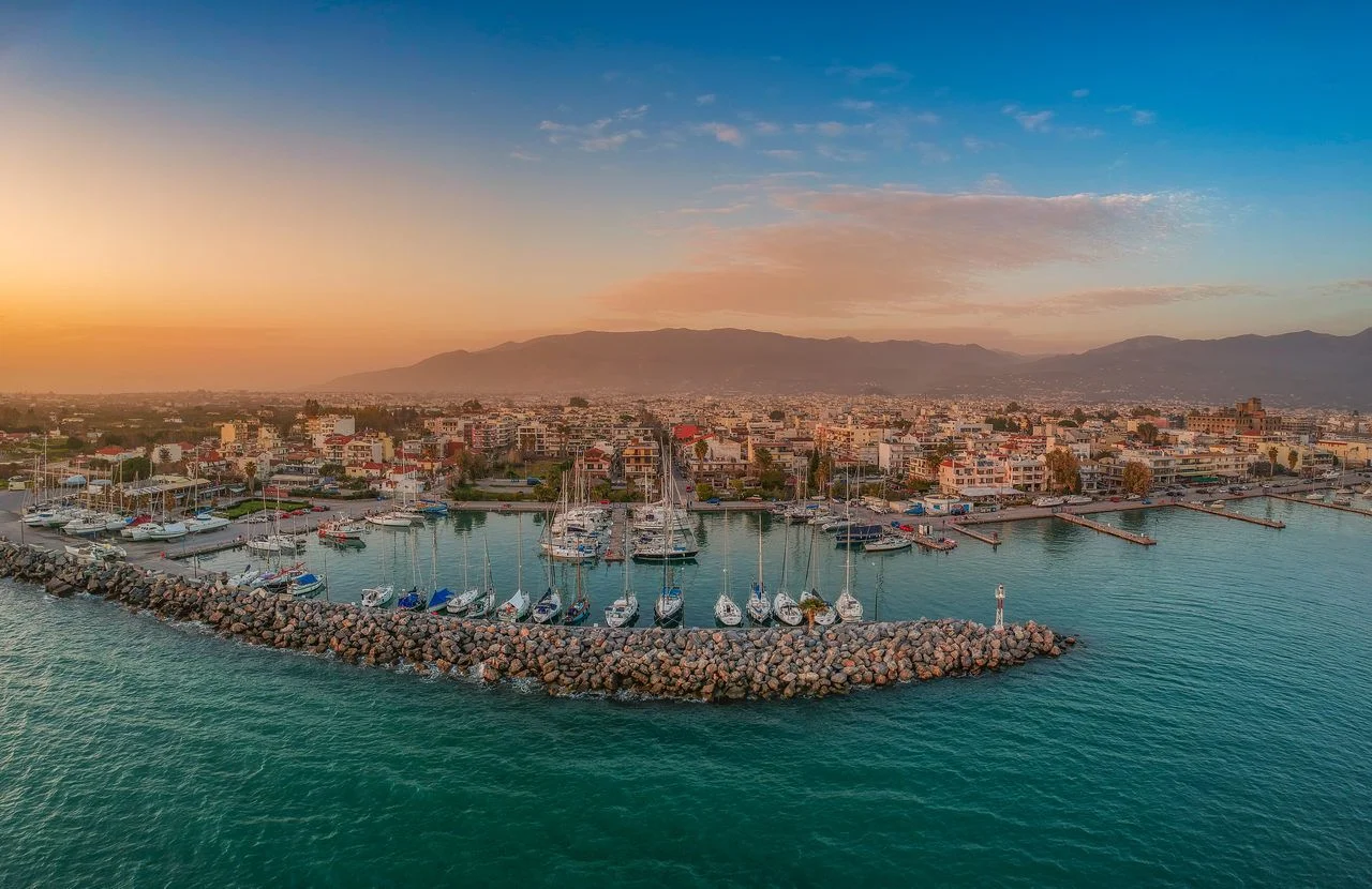 Idyllic landscape flying above Kalamata’s Marina at sunset. Aerial photography of Kalamata city, Messenia, Peloponnese, Greece