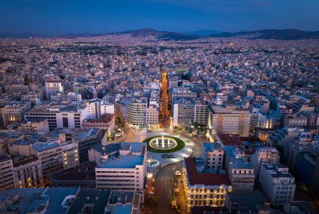 Omonia square aerial view at night time, Athens city center view from the sky. Aerial drone view of night Athens, Greece