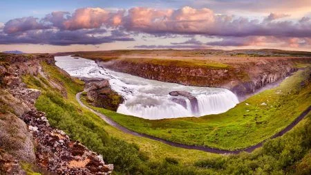 Panoramic view on Gullfoss waterfall on the Hvíta river, a popular tourist attraction and part of the Golden Circle Tourist Route in Southwest Iceland. Golden Waterfall. Travelling concept background.