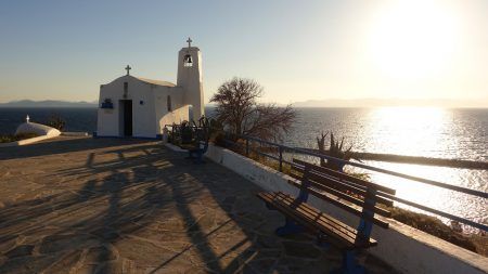 Photo of small picturesque chapel of Agios Nikolaos built on top of a small hull in port of Rafina at dawn, Attica, Greece