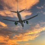 Plane in the sky at sunrise or sunset