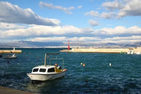 Small fishing boat anchored in the port of Sutivan, on island Brac, Croatia. Split seen in the background. Selective focus.