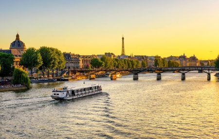 Sunset view of Eiffel tower, Pont des Arts and Seine river in Paris, France. Eiffel Tower is one of the most iconic landmarks of Paris. Architecture and landmarks of Paris.