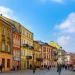 View of traditional colored tenements houses on central streets of Polish city of Lublin in sunny spring day