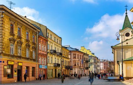 View of traditional colored tenements houses on central streets of Polish city of Lublin in sunny spring day