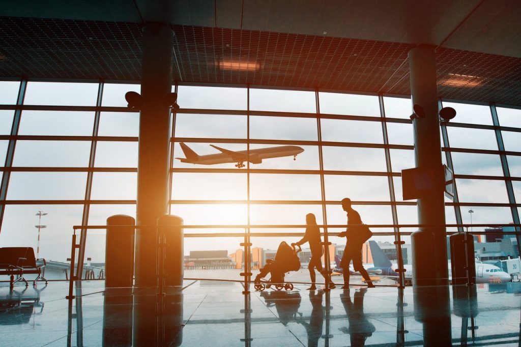people at the airport, silhouette of a young family with a child traveling by plane, vacation