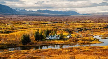 plain thingvellir national park in reykjavik enters to the iceland golden circle. countryside with river, church, houses on mountain landscape in Iceland. best vacations. perfect morning
