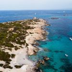 Aerial view of Punta de sa Torre de Ses Portes, a sandy point in the south of Ibiza island in Spain with a medieval round defensive tower ses salines