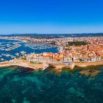 Aerial view over Alghero old town, cityscape Alghero view on a beautiful day with harbor and open sea in view. Alghero, Italy. Panoramic aerial view of Alghero, Sardinia, Italy.