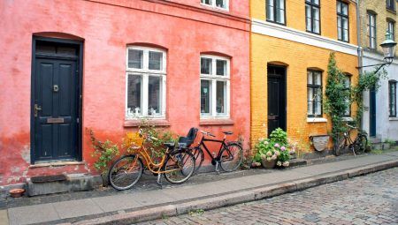 Colorful street, doors, windows, red and yellow walls and bicycles with a bin in the old town, Copenhagen, Denmark