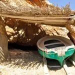 Fisherman boat under the shadow local tradition beautiful scenery old bay on the rocks shelter under the bright sun Ibiza island