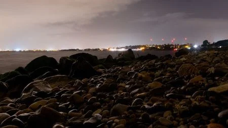 Long exposure panorama over the sea and beach of Margine rosso, Poetto, near Cagliari, Italy at night