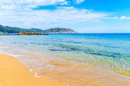 Sea wave on sandy Es Figueral beach, Ibiza island, Spain
