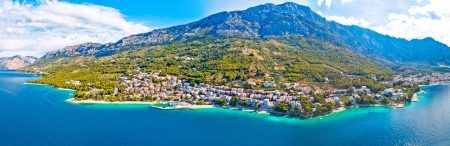 Town of Breal beach and Biokovo mountain aerial panoramic view, Makarska riviera in Dalmatia, Croatia