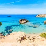 View of Cala Tarida bay with rocks in turquoise sea water, Ibiza island, Spain