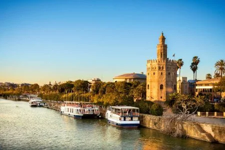View of Golden Tower (Torre del Oro) of Seville, Andalusia, Spain over river Guadalquivir at sunset