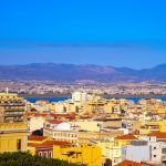 an aerial view of Cagliari, in Sardinia, Italy, with the Montelargius lake and Quartu Sant Elena in the background