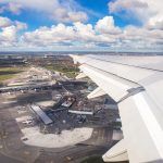 Aerial view of Copenhagen airport or Kastrup (Danish) airport and Copenhagen city from window seat of airplane takeoff over Copenhagen Airport for passenger transportation in Denmark in Europe