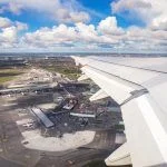 Aerial view of Copenhagen airport or Kastrup (Danish) airport and Copenhagen city from window seat of airplane takeoff over Copenhagen Airport for passenger transportation in Denmark in Europe