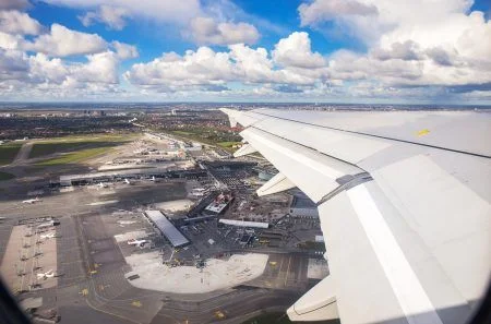 Aerial view of Copenhagen airport or Kastrup (Danish) airport and Copenhagen city from window seat of airplane takeoff over Copenhagen Airport for passenger transportation in Denmark in Europe