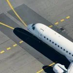 Aerial view of airport. Airplane taxiing to runway before take off.