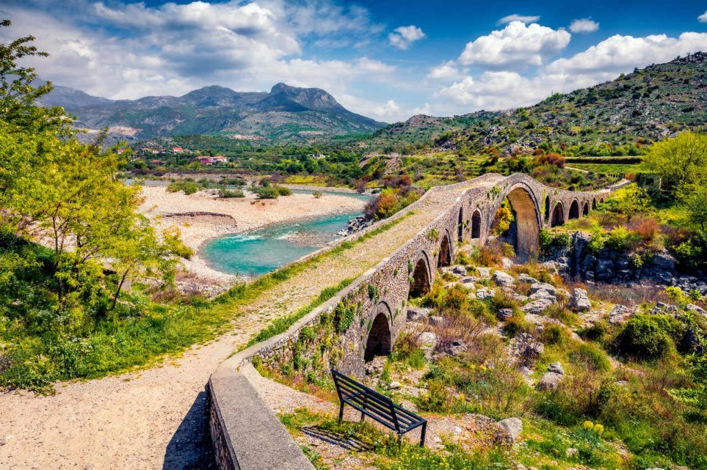 Amazing spring view of Old Mes Bridge. Stunning morning landscape of Shkoder. Picturesque outdoor scene of Albania, Europe. Traveling concept background.