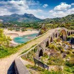 Amazing spring view of Old Mes Bridge. Stunning morning landscape of Shkoder. Picturesque outdoor scene of Albania, Europe. Traveling concept background.