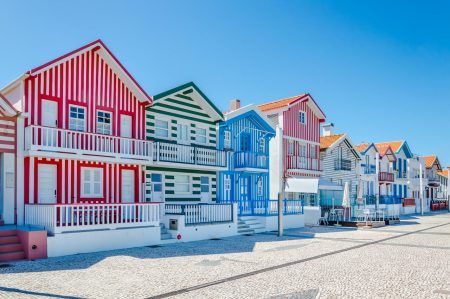 Costa Nova, Portugal colorful striped houses called Palheiros with red, blue and green stripes. Costa Nova do Prado is a beach village resort on Atlantic coast near Aveiro.