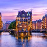 District warehouse (Speicherstadt) in Hamburg, Germany, at dusk. View of the Wandrahmsfleet. The on-site warehouse district is located in Hamburg’s HafenCity port.